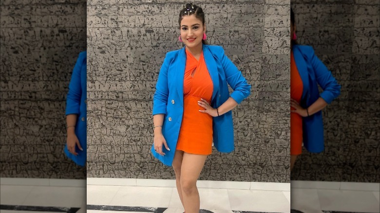 Girl wearing orange dress with blazer