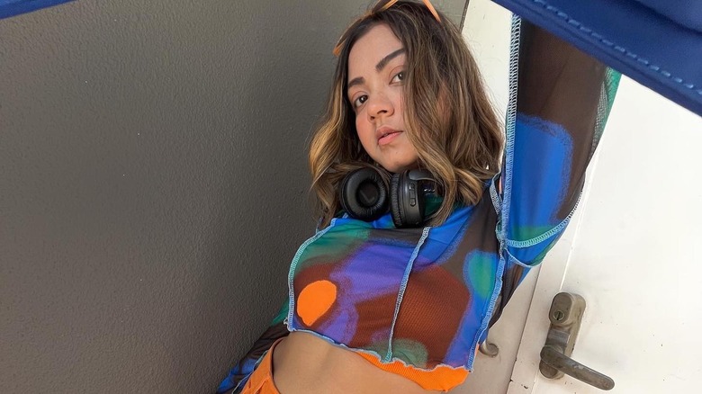 Influencer wearing blue and orange top