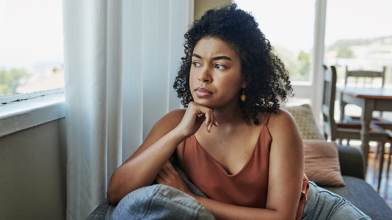 woman looking out window