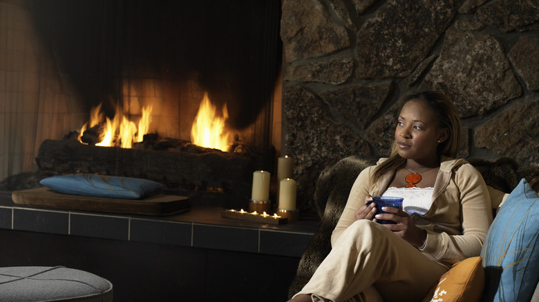 woman sitting next to fire
