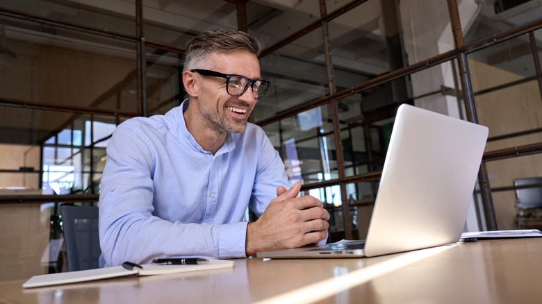 Man with laptop and notebook