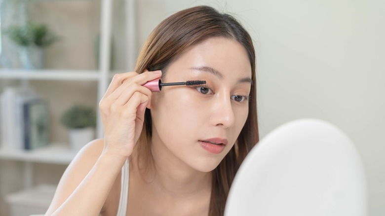 Girl applying mascara