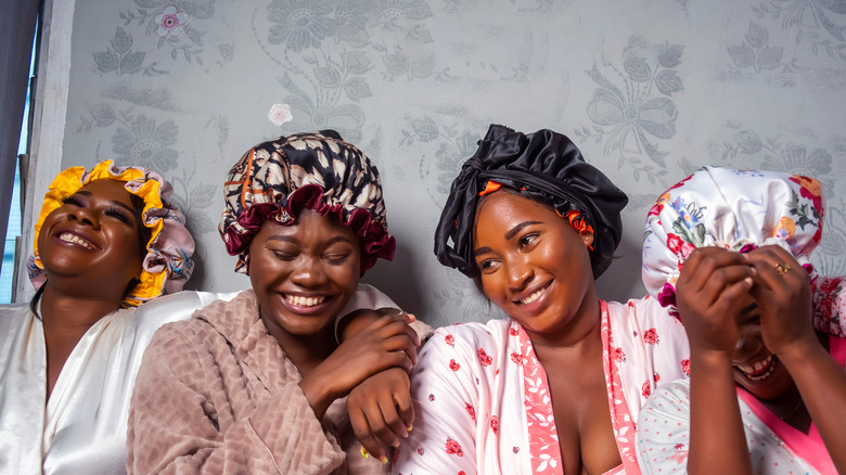 women wearing robes and bonnets