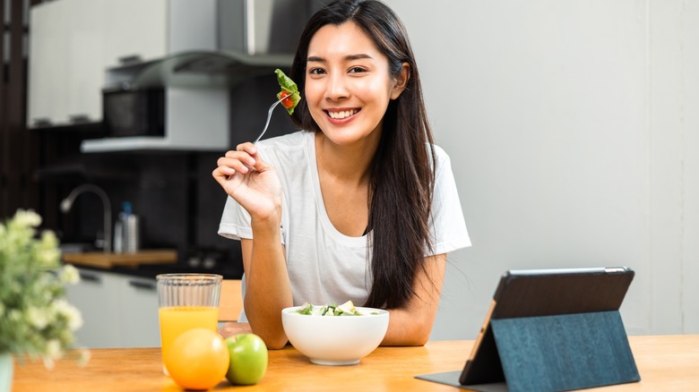 Woman eating salad