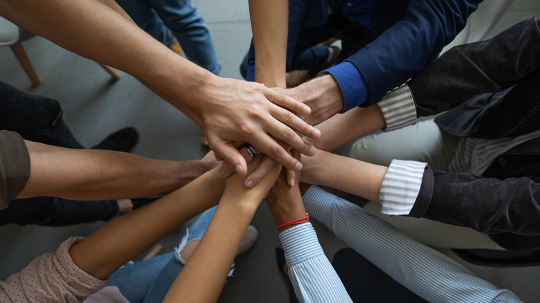 Group handshake showing team building