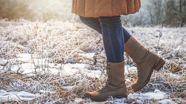 woman wearing winter boots in snow