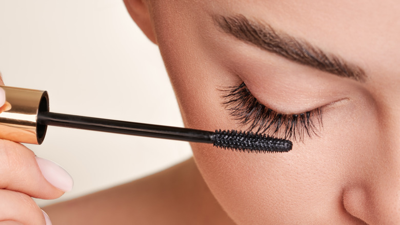 Woman applying mascara