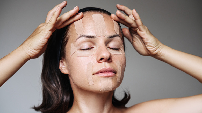 A woman with medical tape applied to her face