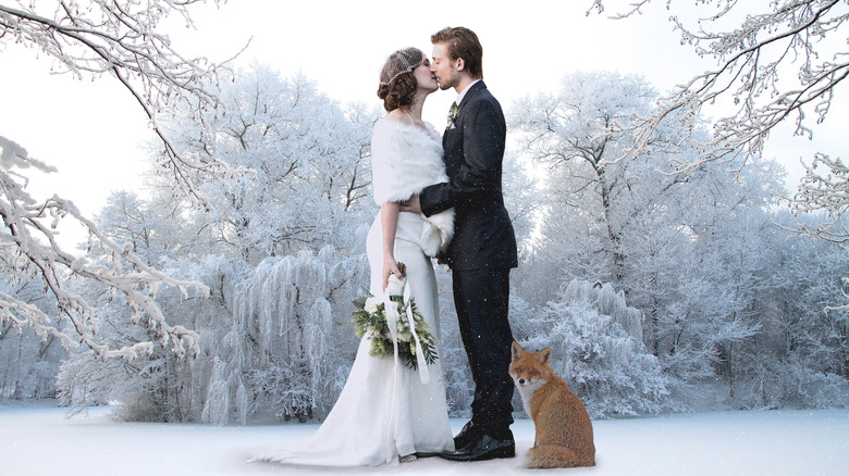 Couple kissing at winter wedding