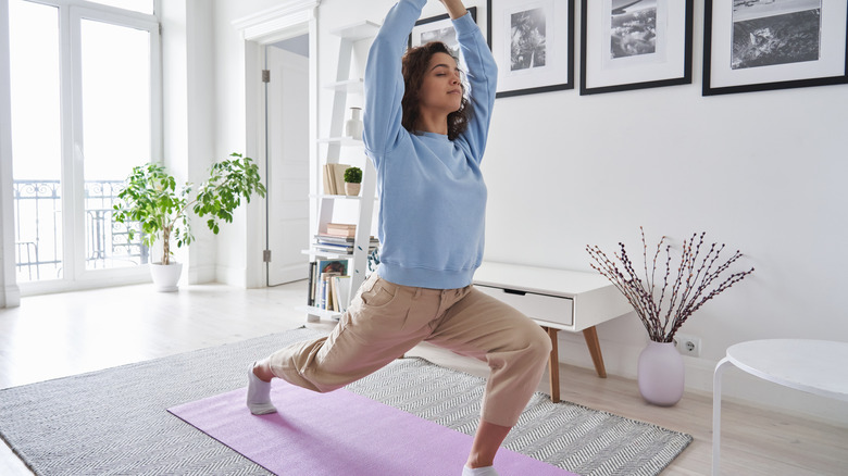 Woman practicing yoga at home