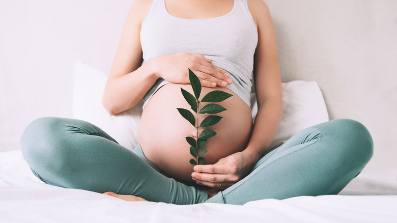 Woman meditating self care while pregnant