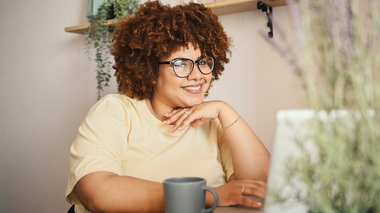 woman smiling at her desk