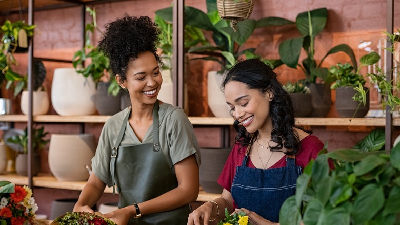 women florists talking while making arrangements