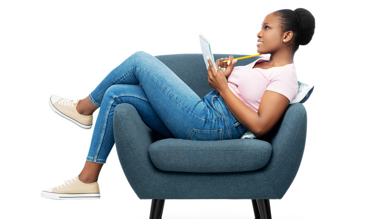 sitting woman writing a list