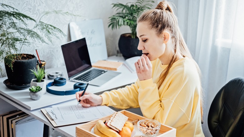 woman with healthy food at desk
