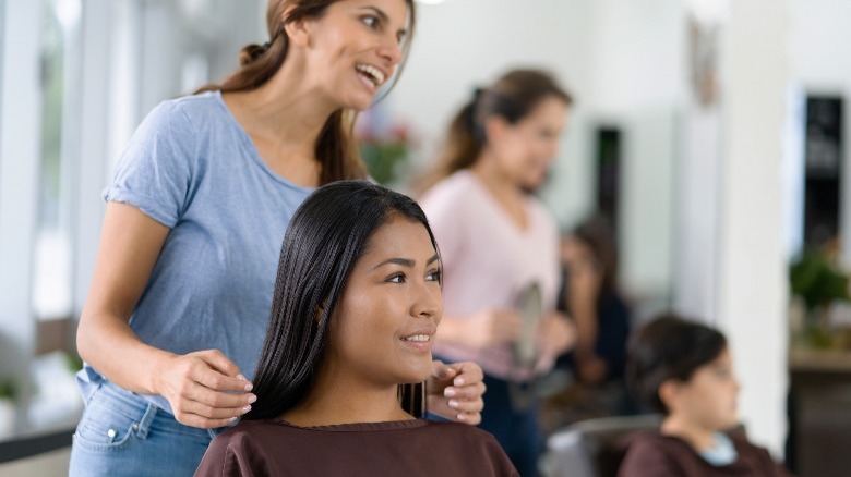 Hairdresser speaking with her client