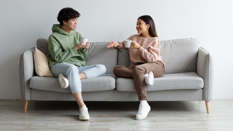 Couple talking on couch