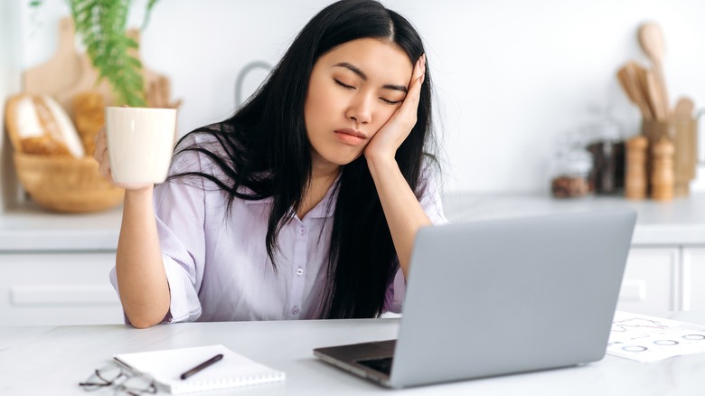 woman falling asleep while working