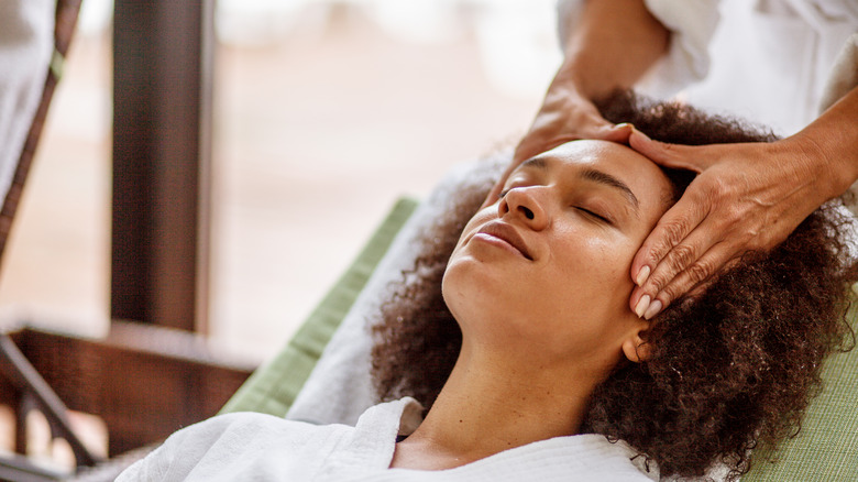 Woman receiving scalp and head massage