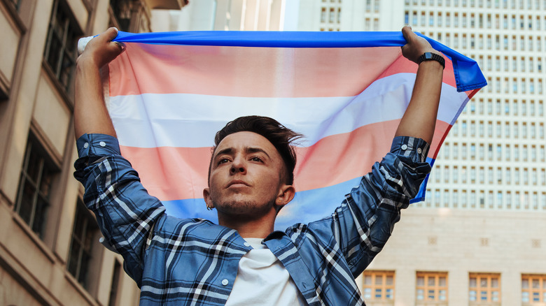 man with trans flag