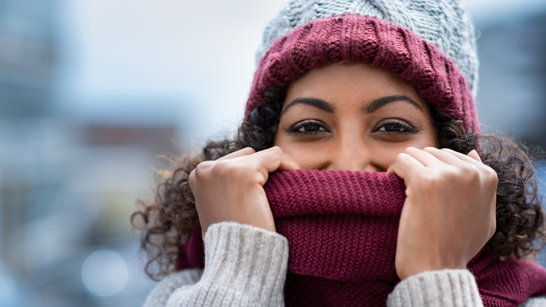 Woman covering face with scarf