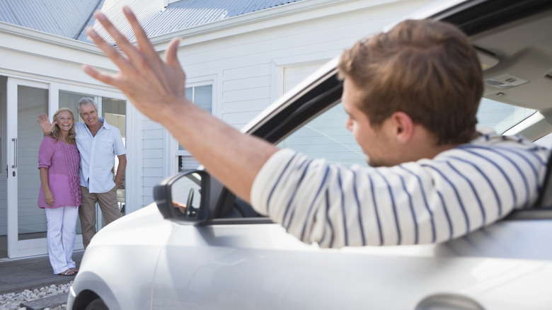 man waving goodbye to parents