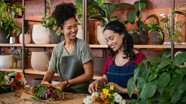 Two coworkers chatting in florist shop