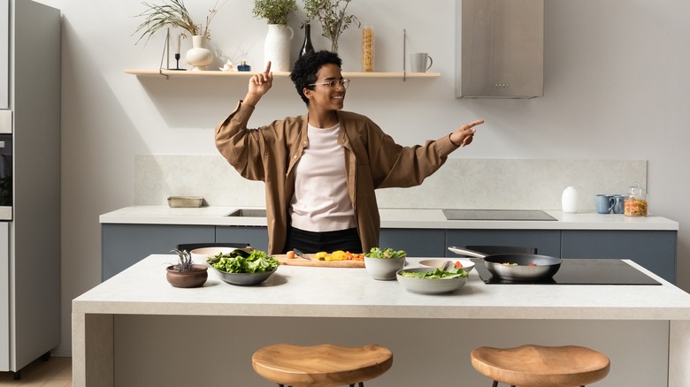 Woman dancing while cooking