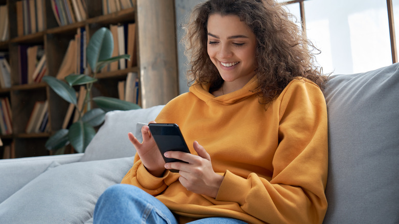 Woman smiling at phone