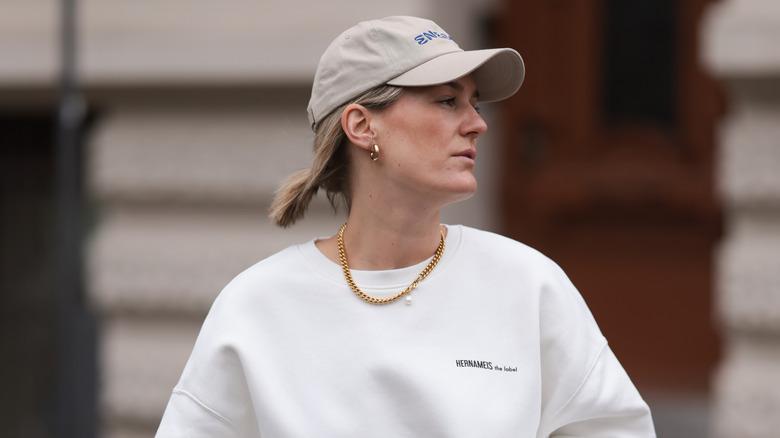 woman wearing gold chain with sweatshirt