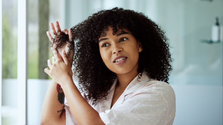 Woman finger combing hair ends 