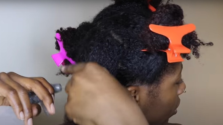 Woman sectioning her hair 