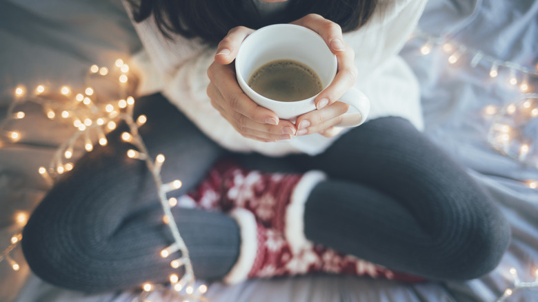 Woman drinking coffee at Christmas