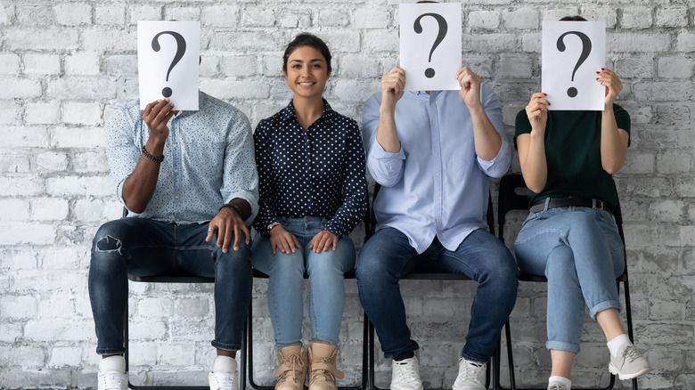 Four people sitting, three hidden