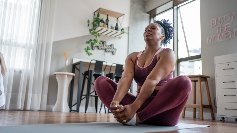 woman stretching on mat