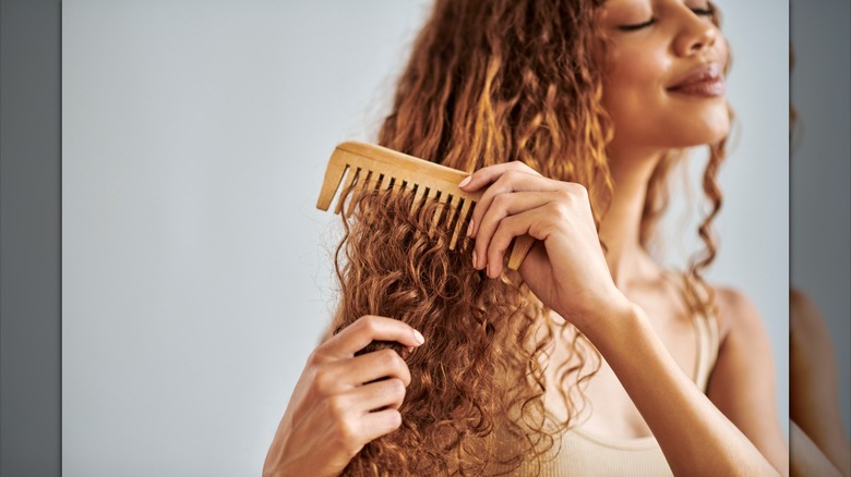Woman combing out curls