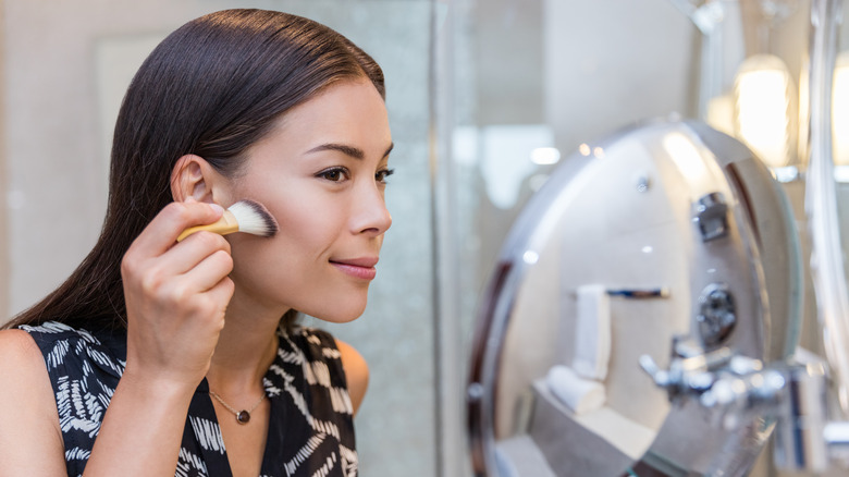 Woman applying foundation