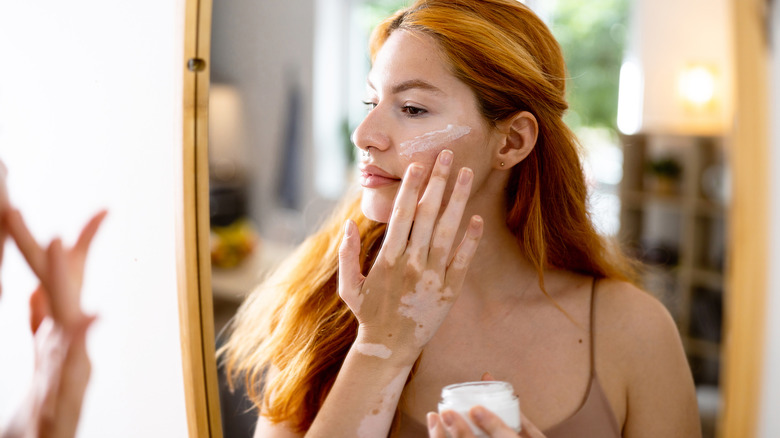 Woman applying face cream