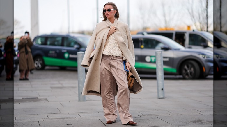 Woman wearing cream coat