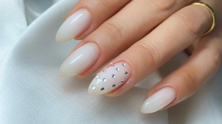 woman wearing milk nails with gems