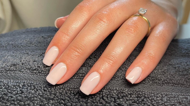 woman with milky white nails