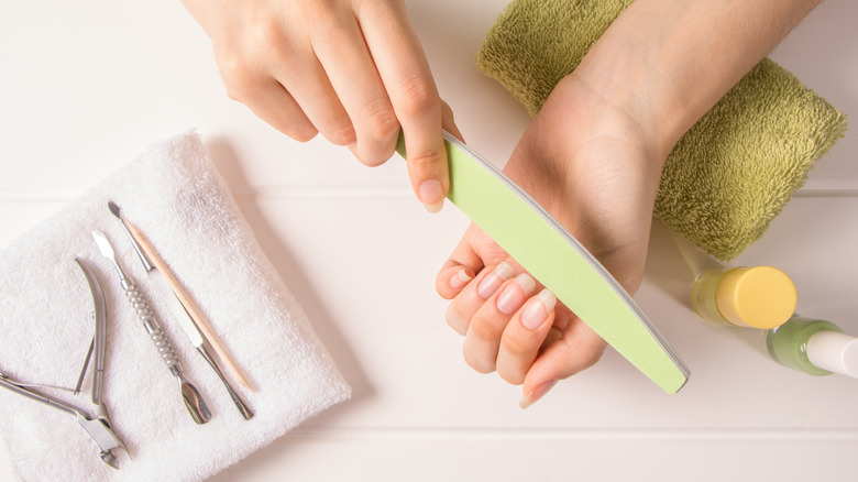 woman filing long nails