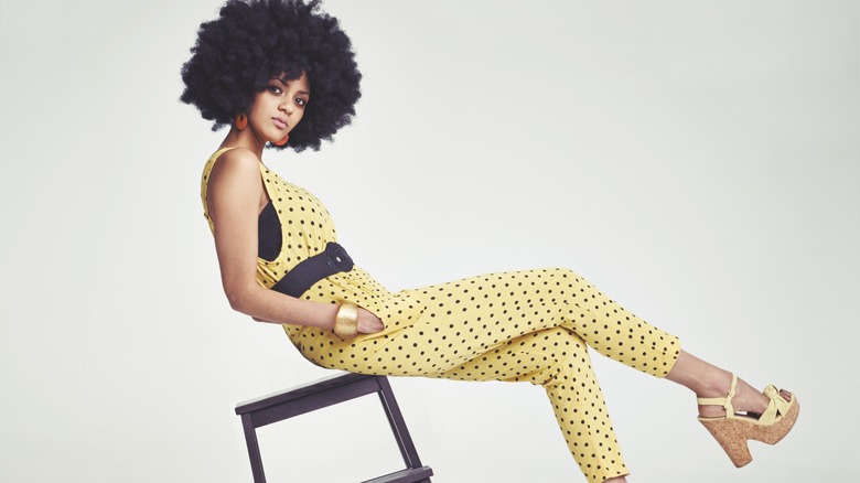 Woman in yellow polka dot jumpsuit