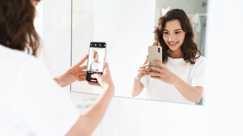 Woman taking a mirror selfie