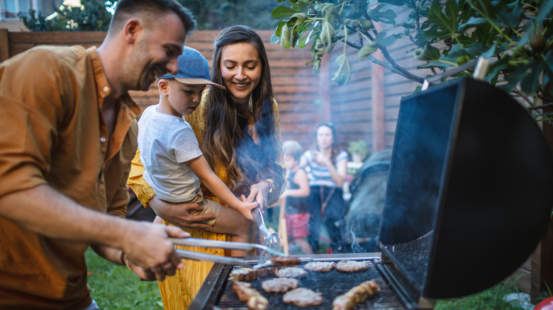 Family grills at barbecue 