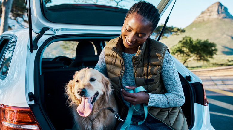 Woman and dog travel via car