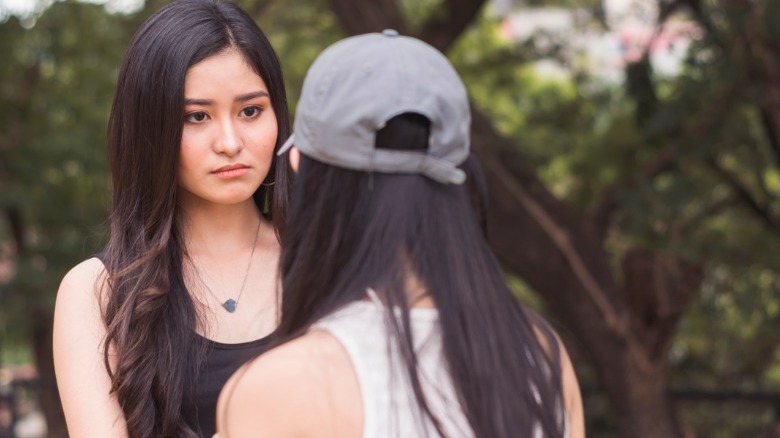 Woman looking angry at friend