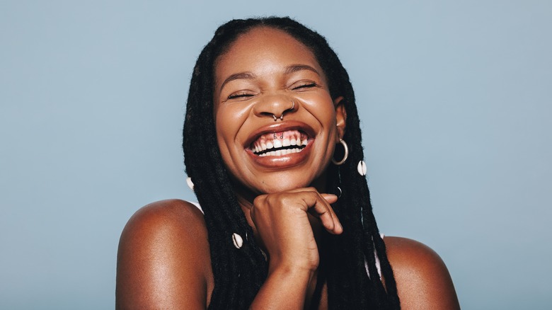 Smiling woman with many piercings