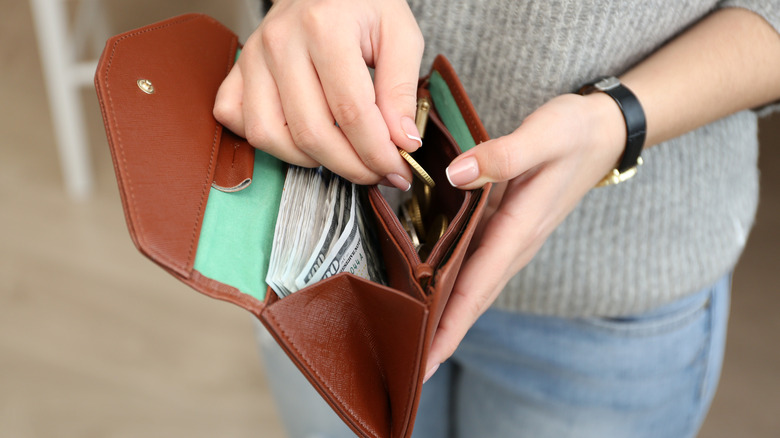 woman opening wallet