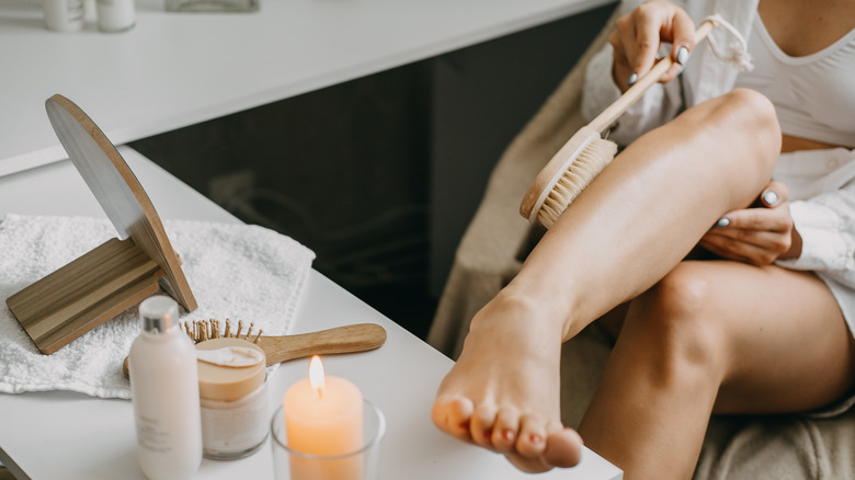 Woman exfoliating with dry brush